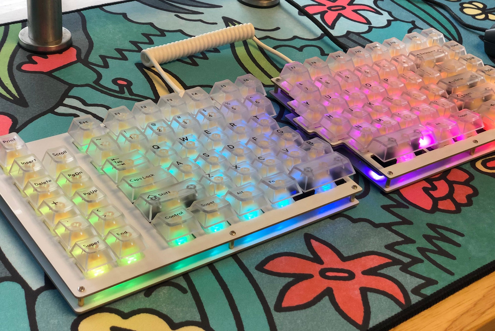 Fully built Sinc keyboard with clear keycaps and a rainbow gradient on the per-key LEDs.
