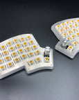 Iris keyboard with shiny stainless steel plates and rotary encoders replacing the upper thumb key on each half.