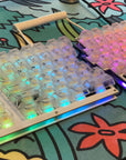 Fully built Sinc keyboard with clear keycaps and a rainbow gradient on the per-key LEDs.