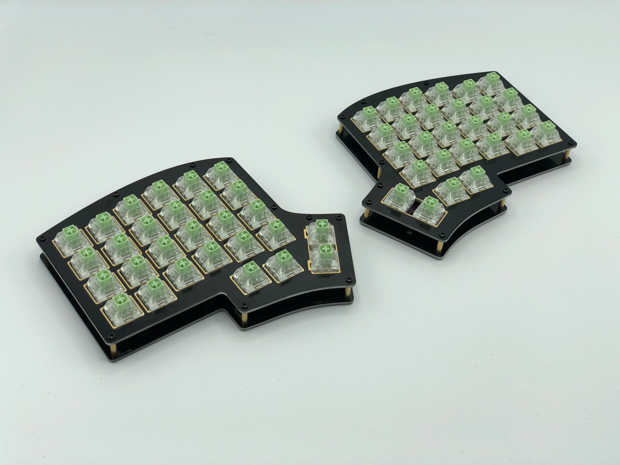 Iris keyboard built with black FR4 plates, Box Jade switches, and no keycaps.