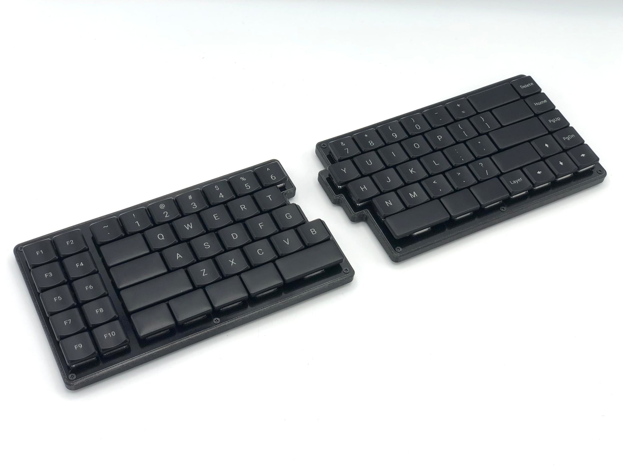 Fully built Cepstrum keyboard with black keycaps and a black 3D printed middle layer.