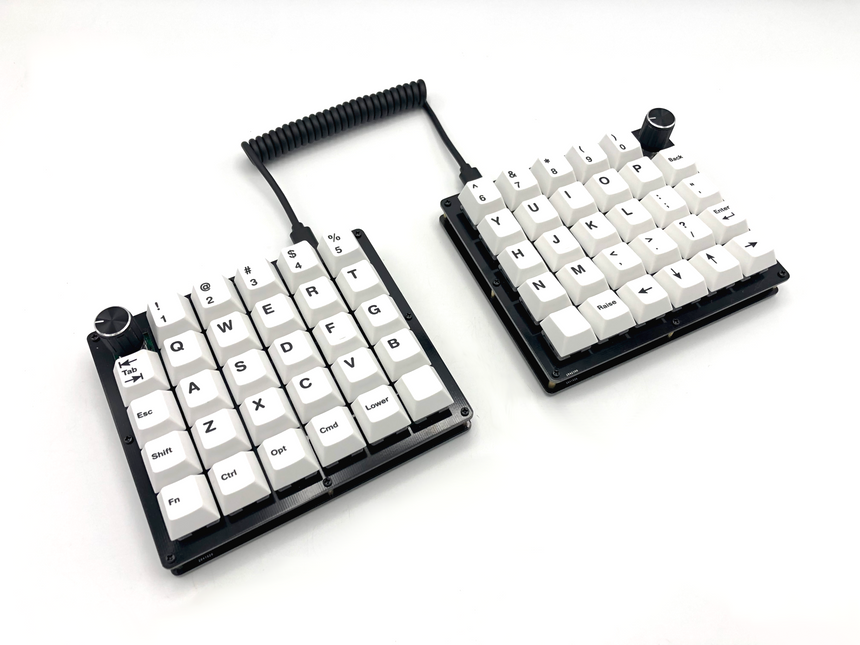Nyquist keyboard with a rotary encoder on each half and Icebergo keycap set.