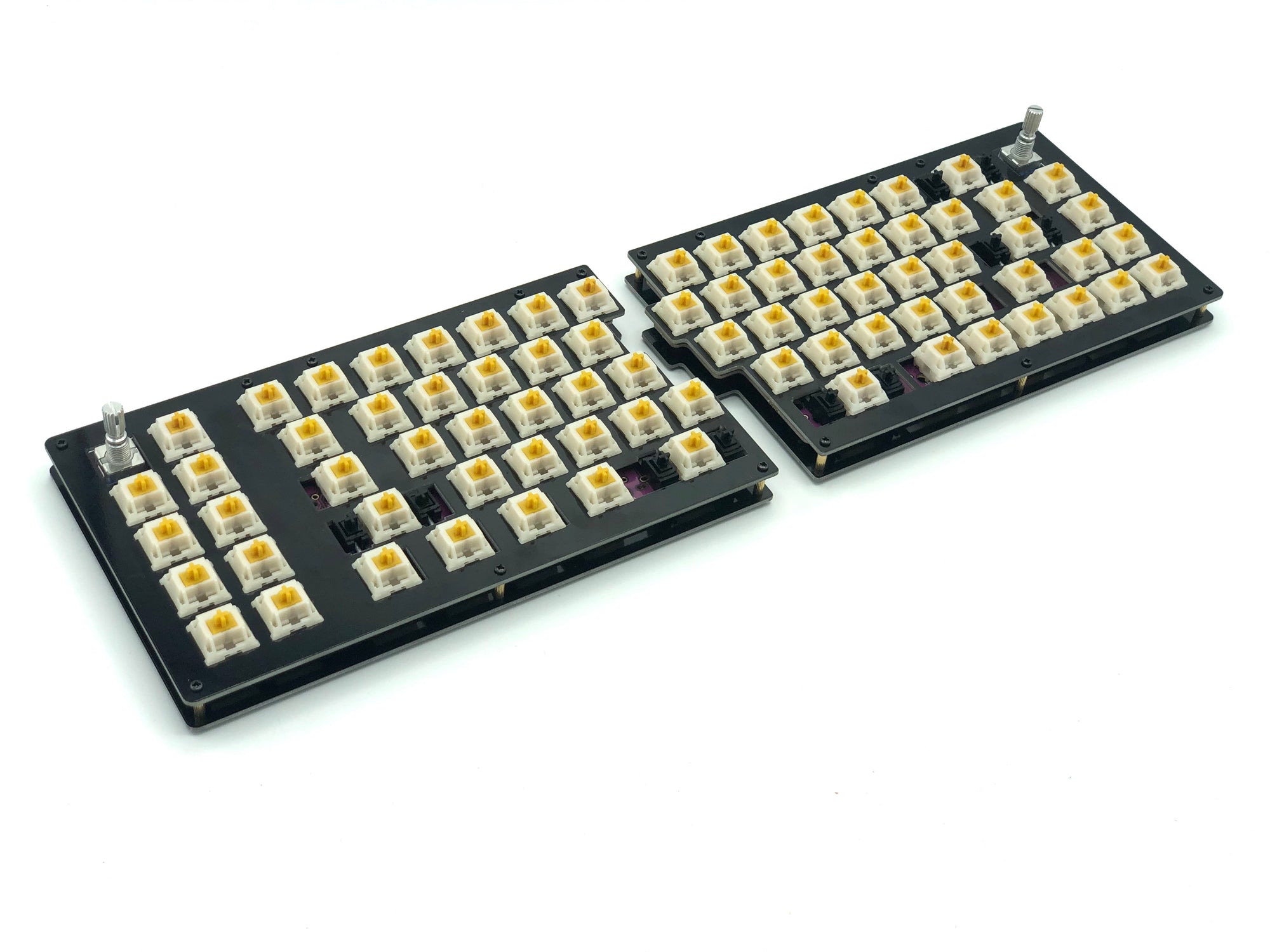 Quefrency keyboard built with yellow and white switches, rotary encoders in the outer corners, and no keycaps.